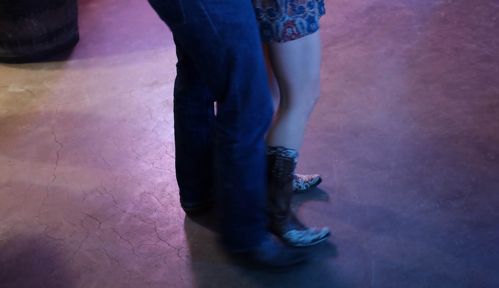 Legs of man and woman on dancefloor dancing two step