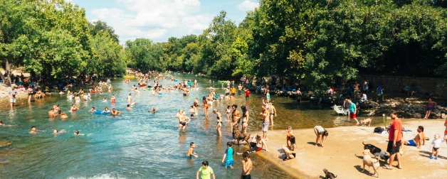 Locals the enjoy refreshing waters of Barton Springs pool on a hot summer day