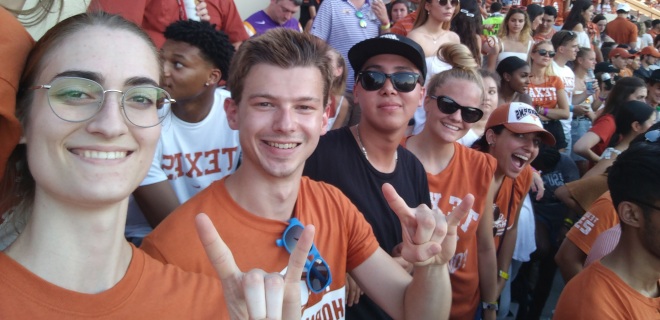 chris hahn poses with friends at a football game