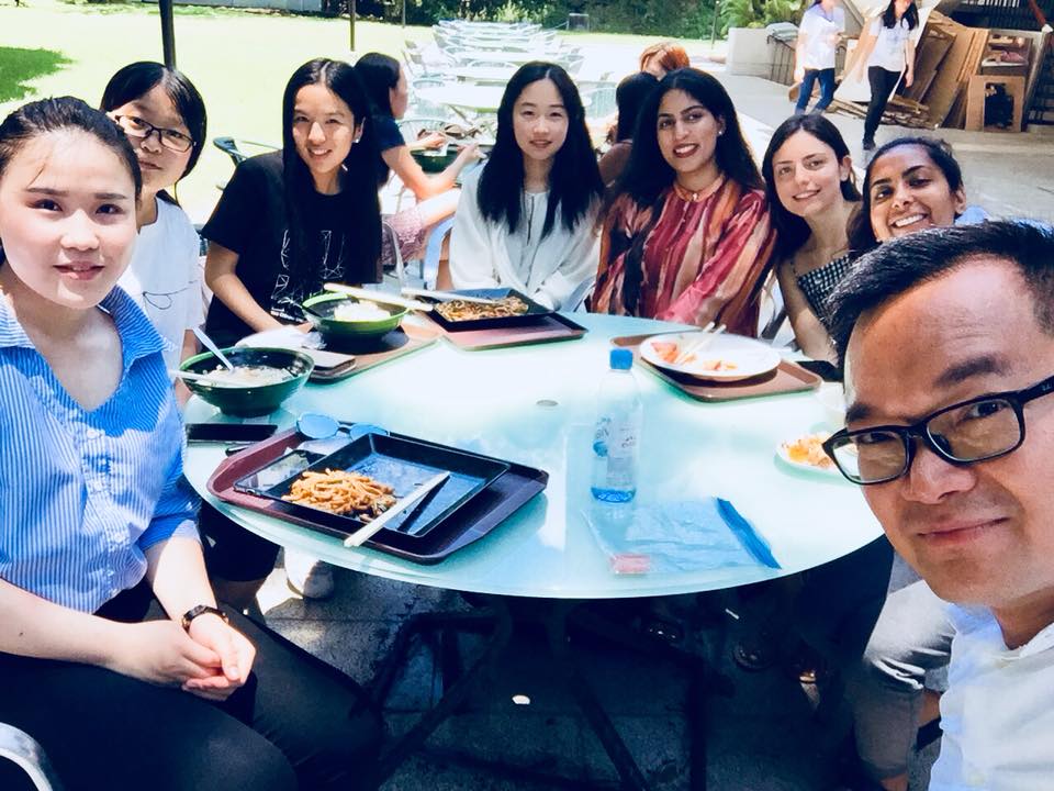 Saera with her friends and Professor in Hong Kong sitting down and eating