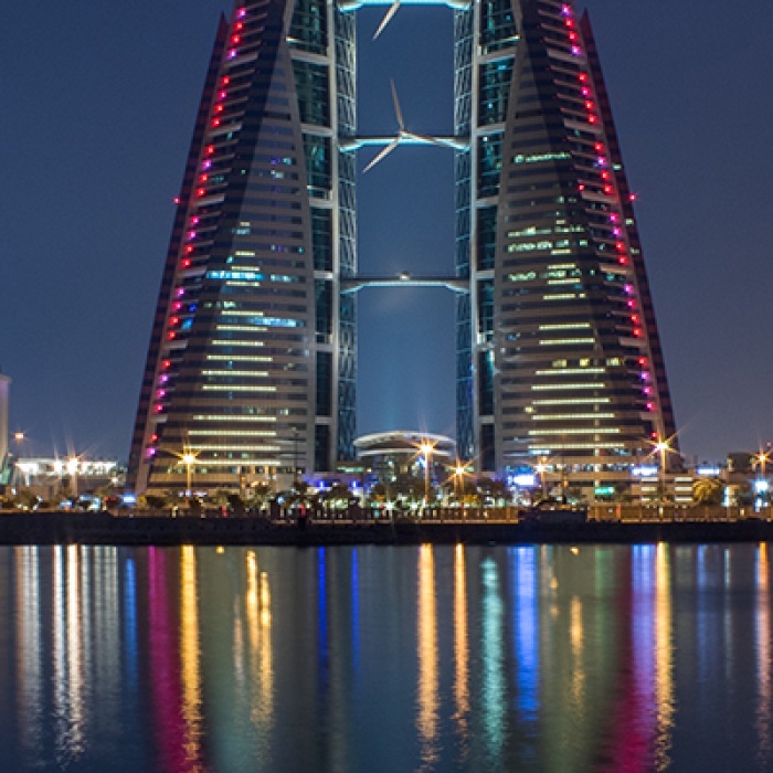 Bahrain at night with colorful city lights reflect in water