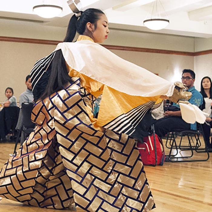 Asian dancer in traditional clothing on UT campus
