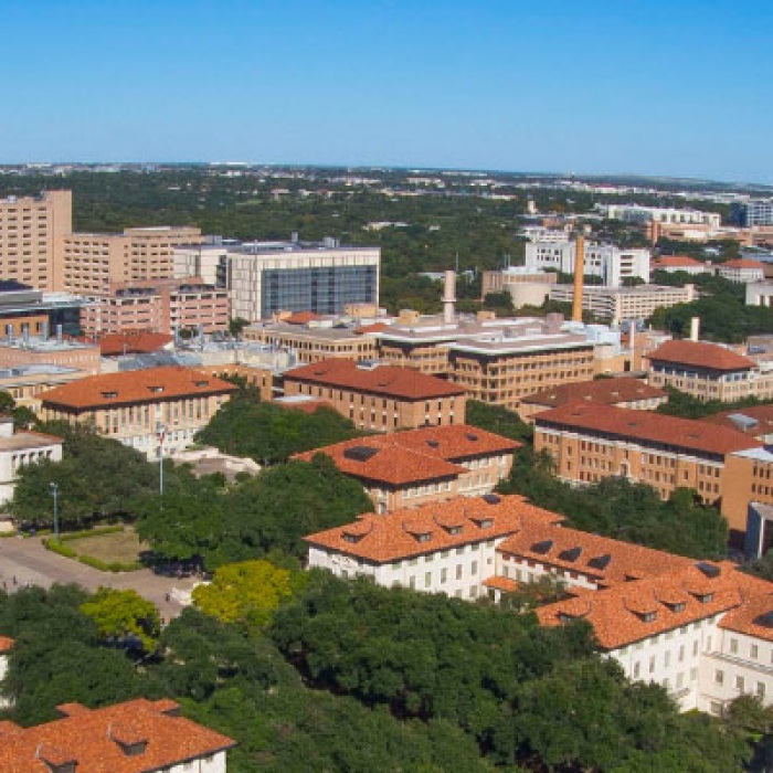 Aerial view of the campus with fisheye effect with against bright blue sky with UT Tower standing tall above campus buildings