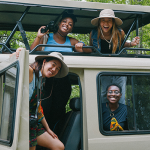 Students abroad in safari hats and van.