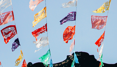 colorful flags hanging in the sky in latin america