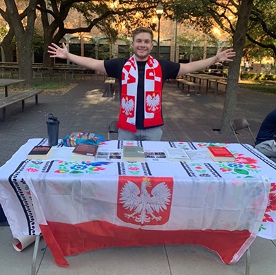 Nathan Silverstein stands behind the UT Polish Club event table